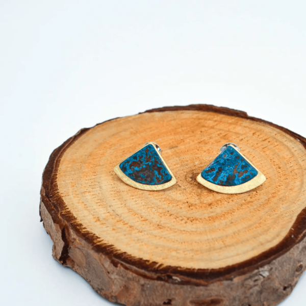Art Deco Style Earrings placed on a slice of wood